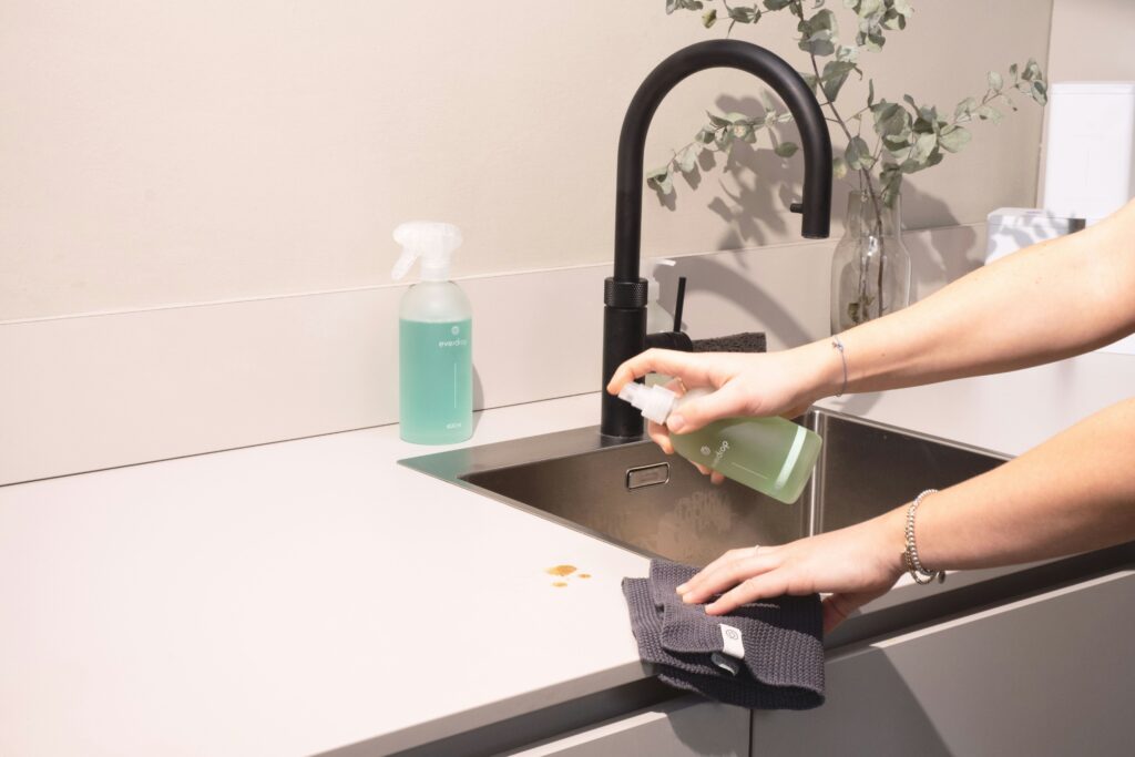 Wiping a kitchen sink and benchtop